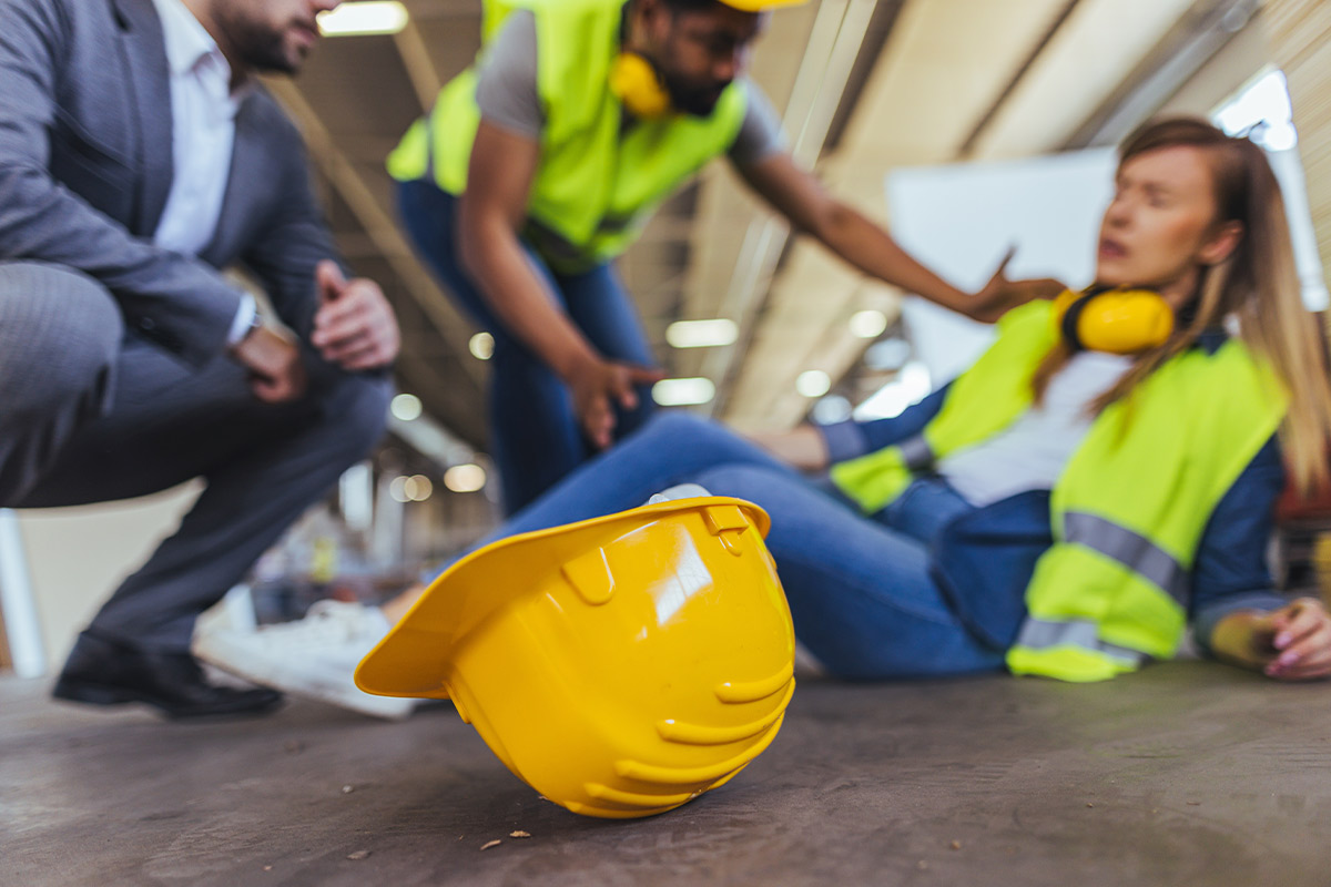 Team of construction workers in hard hats and safety vests, focused on assessing project risks at a construction site.
