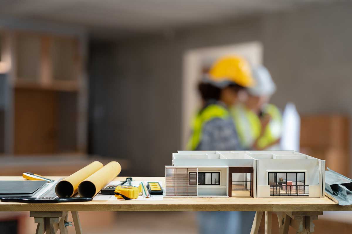 Construction house and building. Repair work. dof laptop computer and office construction on table in office blurred background.Architect concept.
